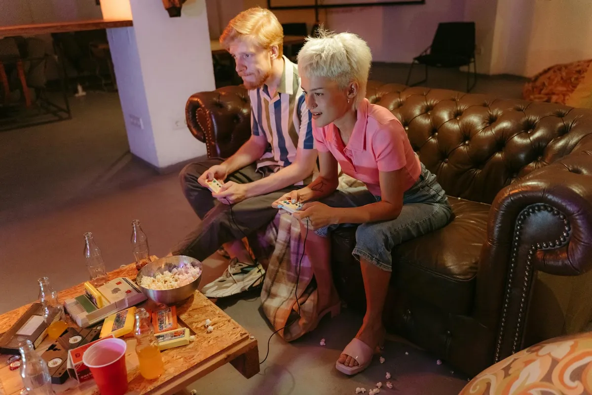 Two players on a couch with controllers